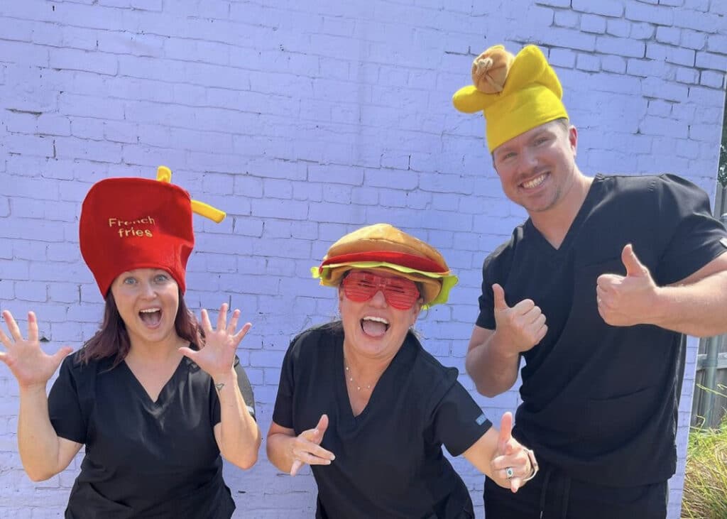 Three Azle Dental Care dentists in silly hats